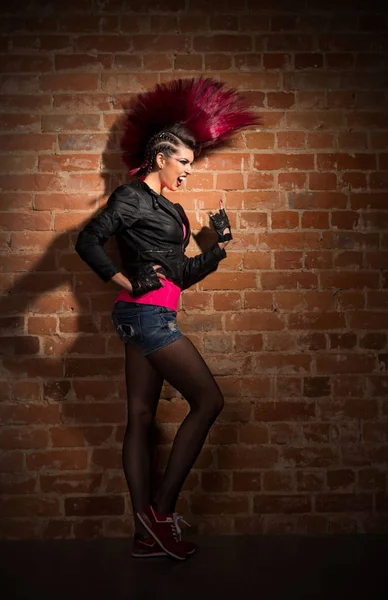 Punk girl on brick wall background — Stock Photo, Image