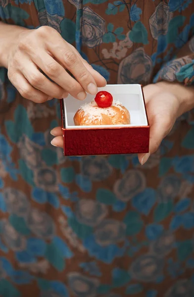 Frau hält Eclair in der Box — Stockfoto