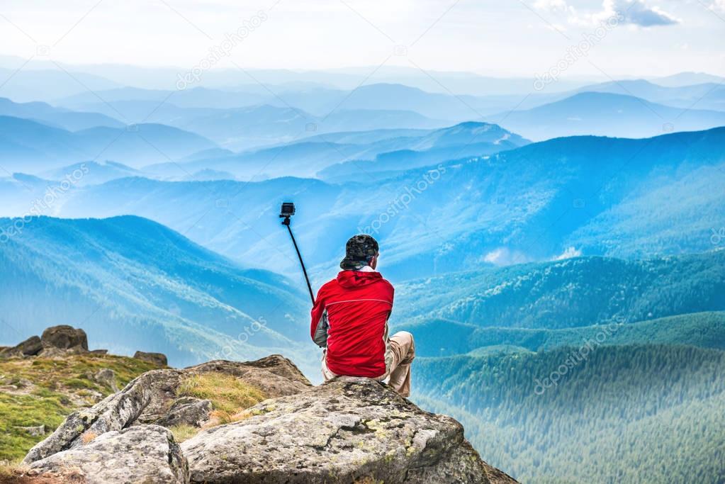 Young man on mountain taking selfie