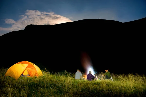 People near illuminated orange tent — Stock Photo, Image