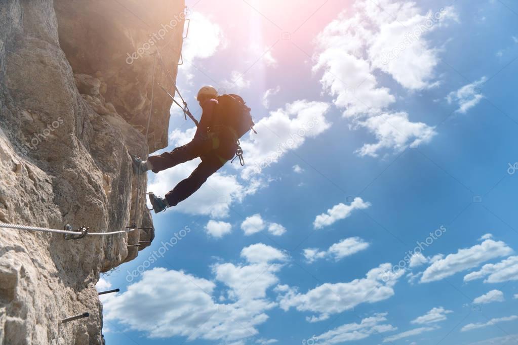 Silhouette of via ferrata climber