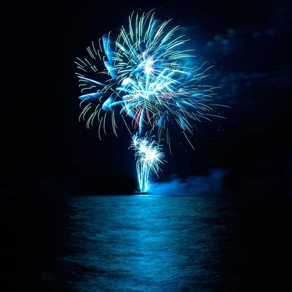 Holiday fireworks above lake — Stock Photo, Image
