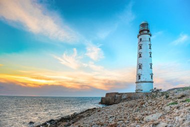 Karadeniz kıyısında günbatımı gökyüzü ile deniz feneri