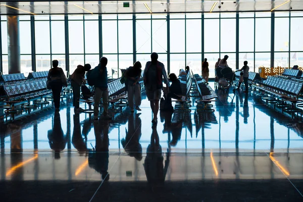 Group of silhouette people in airport go to registration with luggage