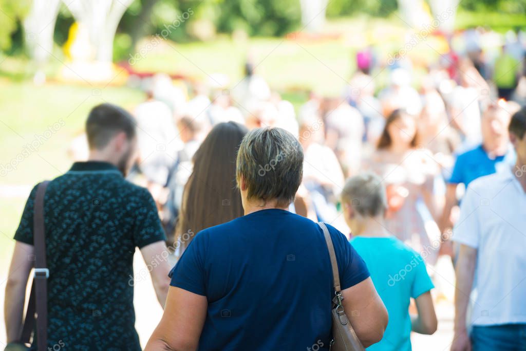 Crowd of people with senior woman on busy street