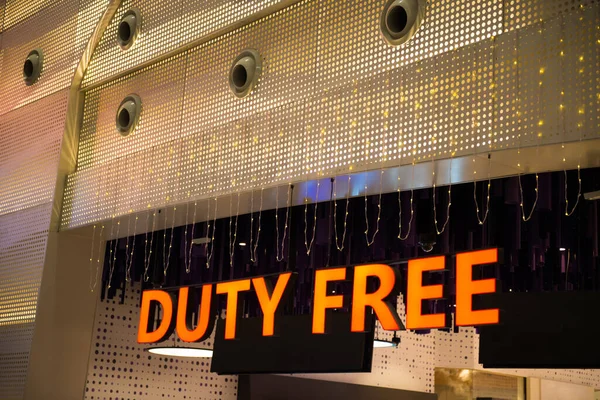 Neon illuminated duty free sign inside international airport