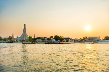 Gün batımında Chao Phraya Nehri 'nin batı kıyısındaki güzel Şafak Tapınağı ya da Wat Arun ve Thonburi manzarası. Bangkok, Tayland