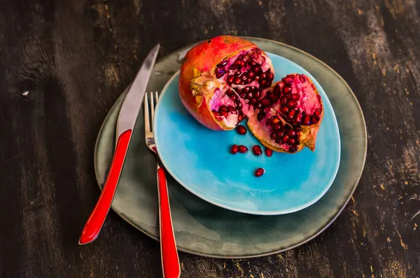 Ripe pomegranate on dark background — Stock Photo, Image