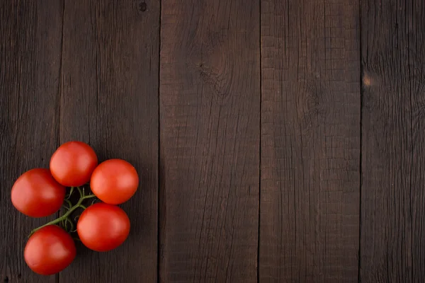 Tomatoes on old wooden table. — Stock Photo, Image