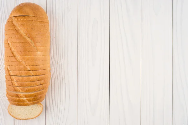 Loaf of bread on a wooden table. — Stock Photo, Image