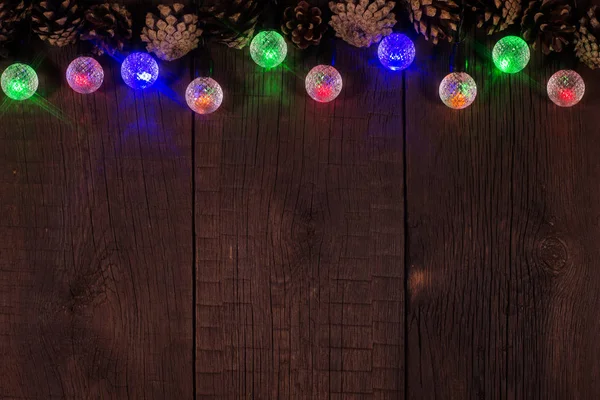 Christmas colorful lights on wooden table with copy space. — Stock Photo, Image