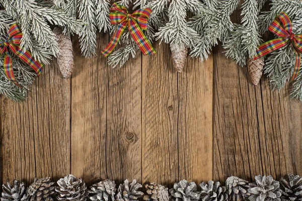 The branch of spruce in the snow on a dark wooden table. Top vie — Stock Photo, Image
