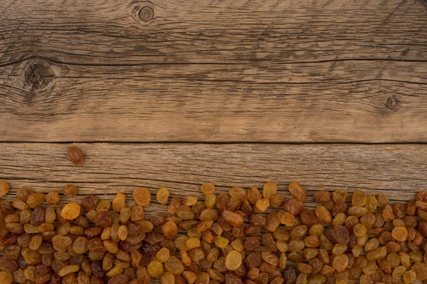 Rosinen auf dem alten Holztisch. — Stockfoto