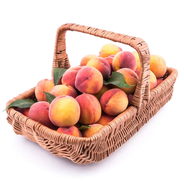 Basket full of fresh peaches isolated on white background. — Stock Photo, Image
