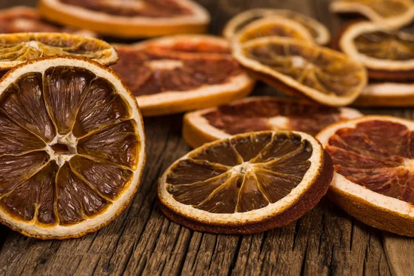 Dried oranges and grapefruits on an old wooden table. — Stock Photo, Image