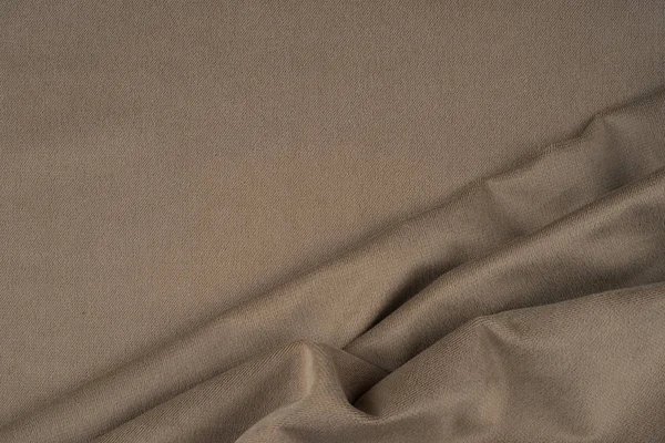 Close up van een wollen weefsel van beige kleur. Abstracte achtergrond — Stockfoto