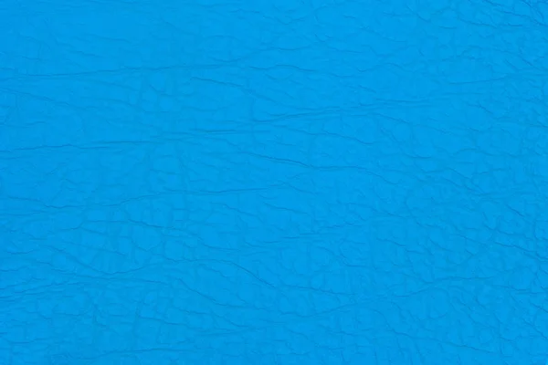 Cuero de imitación de superficie con pliegues en color azul como fondo o textura . —  Fotos de Stock