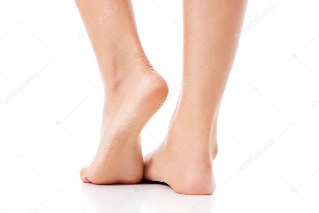 Womens feet on white background.
