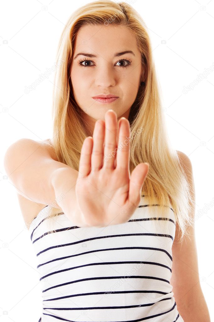 Young woman making stop sign on white background.