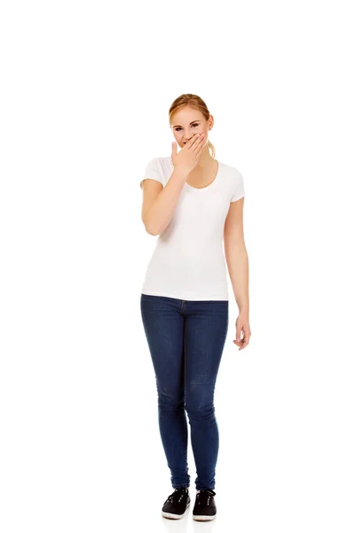 Young woman giggles covering her mouth with hand — Stock Photo, Image