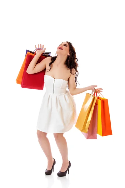 Mujer joven sosteniendo pequeñas bolsas de compras vacías —  Fotos de Stock