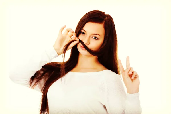 Funny student woman putting hair like moustache — Stock Photo, Image