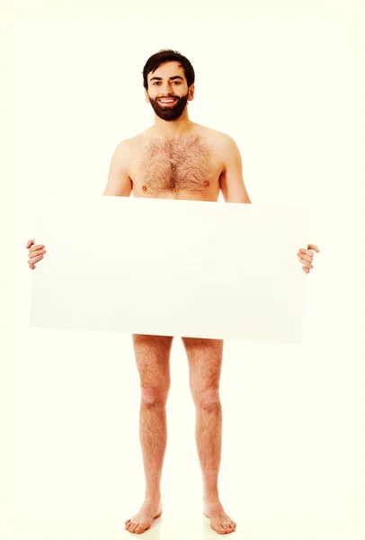 Young shirtless man holding empty banner. — Stock Photo, Image