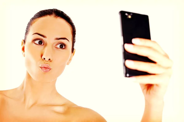 Young nude woman taking selfie — Stock Photo, Image