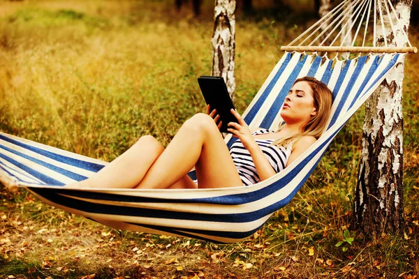 Young woman with tablet on the hammock — Stock Photo, Image
