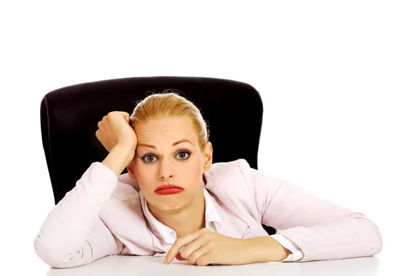 Tired business woman sitting behind the desk — Stock Photo, Image