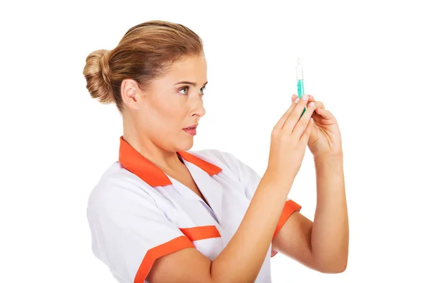 Female nurse or doctor with a syringe in hand — Stock Photo, Image