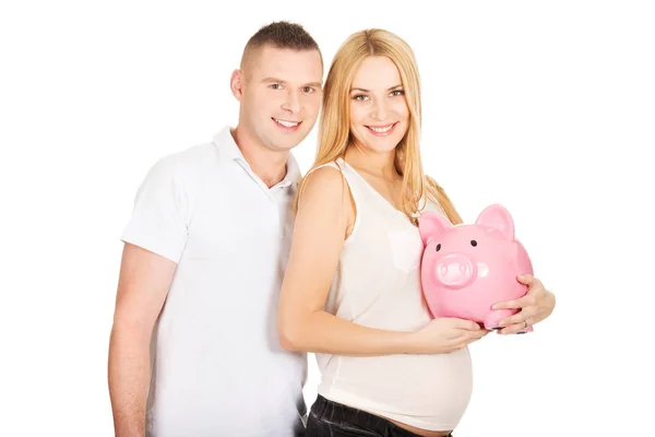 Mooie jonge paar met piggy bank — Stockfoto