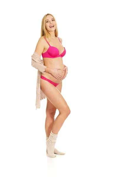 Zwangere vrouw in lingerie en sokken — Stockfoto