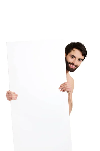 Young shirtless man holding empty banner. — Stock Photo, Image