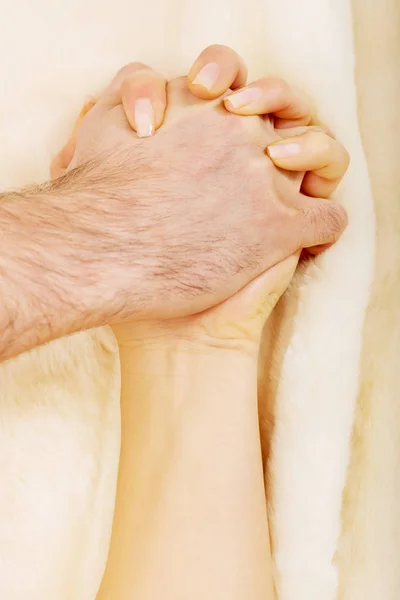 Hands of female and male lying on bed. — Stock Photo, Image