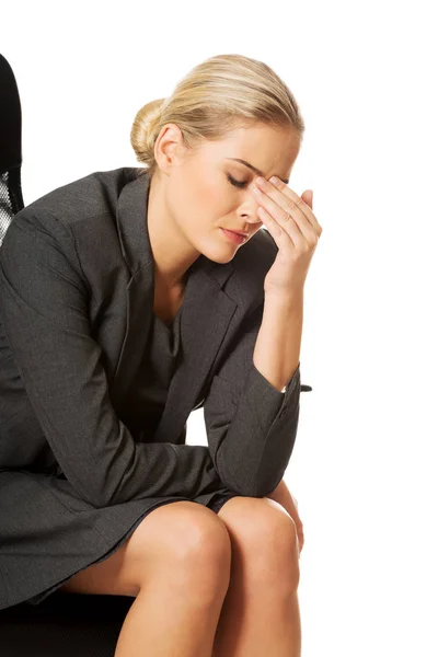 Depressed businesswoman sitting on armchair — Stock Photo, Image