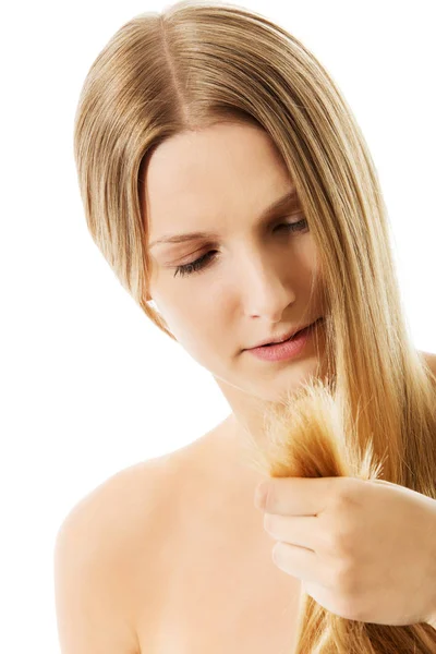 Unhappy sad woman looking at destroyed hair. — Stock Photo, Image