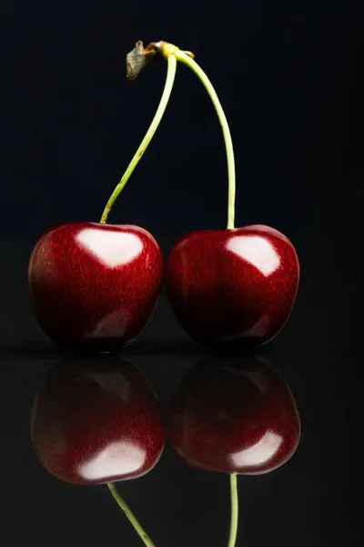 Two juicy fresh cherries on black background — Stock Photo, Image