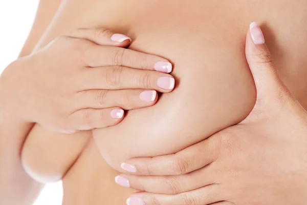 Молода жінка вивчає груди для грудей або ознаки раку молочної залози . — стокове фото