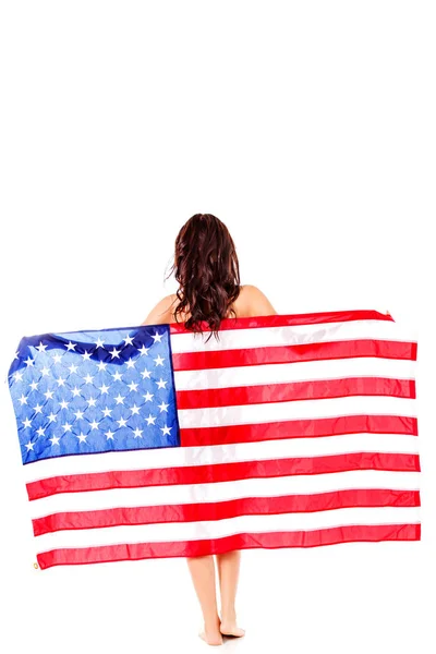 Beautiful brunette woman wrapped into American flag. — Stock Photo, Image