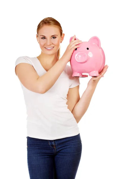 Happy young woman holding piggybank — Stock Photo, Image