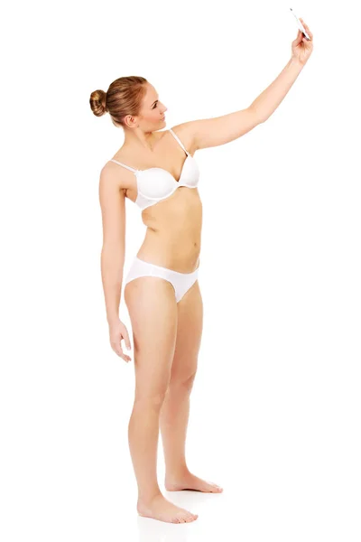 Young woman in underwear makes photo of herself — Stock Photo, Image