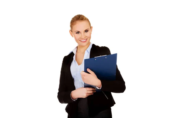Young business woman holding clipboard — Stock Photo, Image