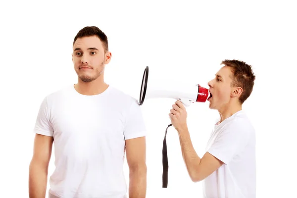 Young man shouting into a megaphone — Stock Photo, Image