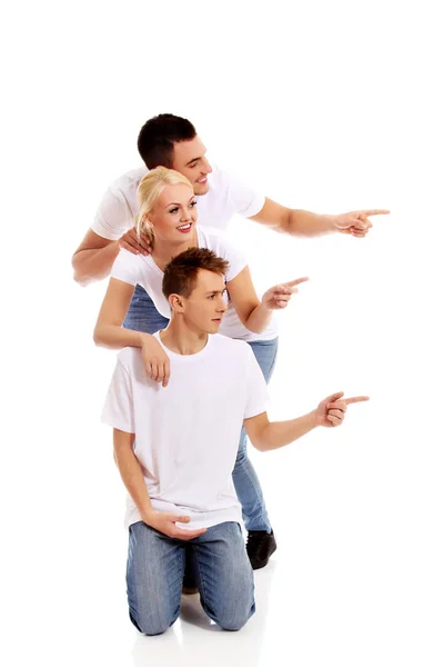 Group of happy people pointing for something — Stock Photo, Image