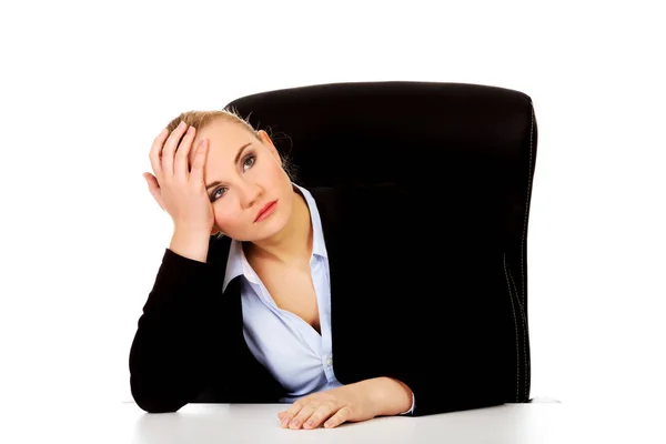 Tired business woman sitting behind the desk — Stock Photo, Image