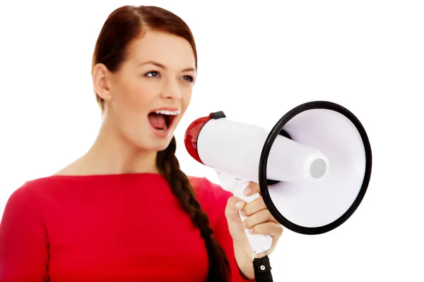 Young angry woman screaming through a megaphone — Stock Photo, Image