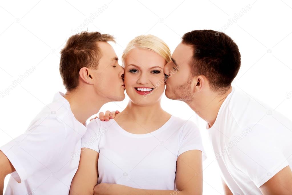 Two guys kissing friend woman cheeks