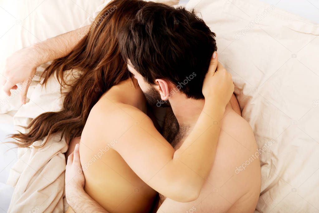Attractive young couple in a loving embrace.