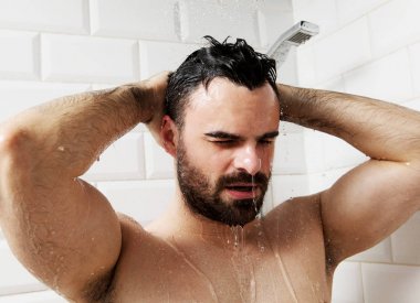 Çıplak yakışıklı genç alarak duş banyoda